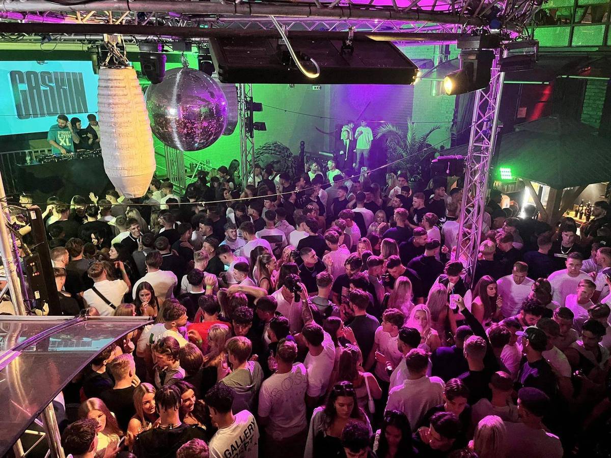 Packed late bar under disco lights