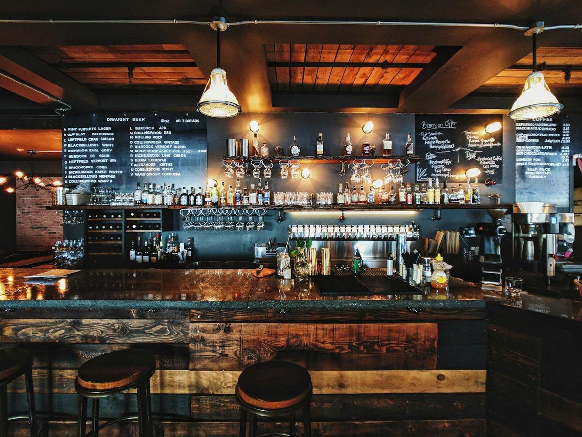 Warm wood pub interior with pints on the bar